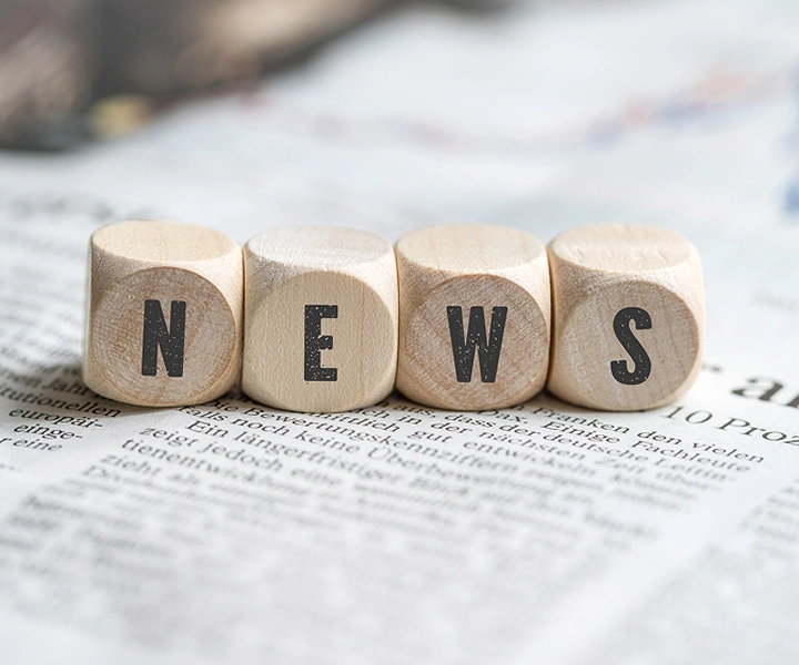 Blocks with the word ‘NEWS’ lying on a newspaper.